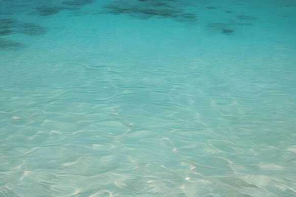 A Clear Blue Water with Small Ripples: A Versatile Background for Creative Projects